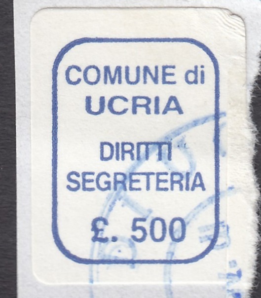 Marca da Bollo del Comune di UCRIA su Carta Bianca di dimensioni 13,5 x 18,5 mm